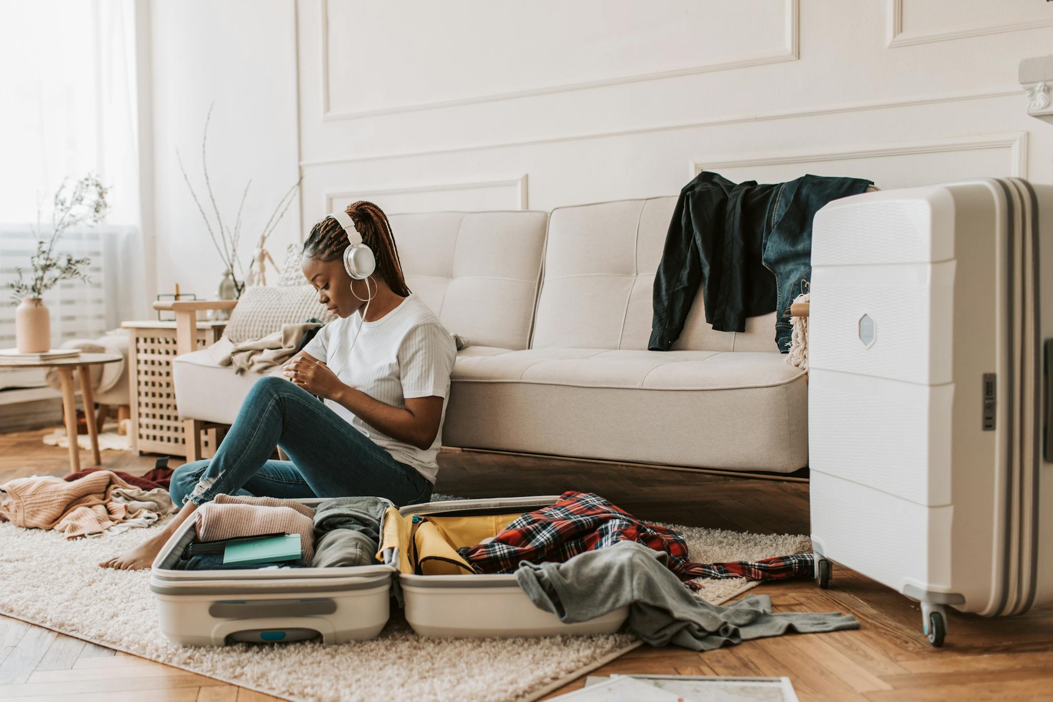 A Woman Sitting on the Floor Beside a Suitcase, cheap flights airline tickets plane tickets cheap airline tickets book flights cheap plane tickets airtickets fly tickets cheap airfare flight deals